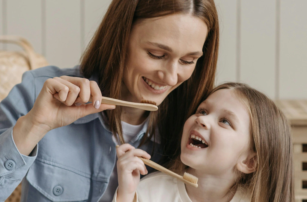 Child brushing teeth with a soft toothbrush