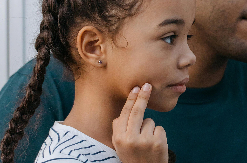 a young girl faced with a dental emergency