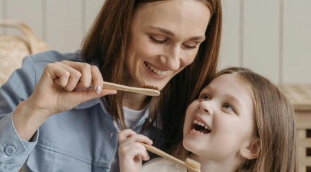 Child brushing teeth with a soft toothbrush