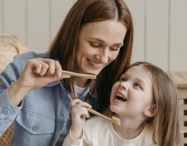 Child brushing teeth with a soft toothbrush