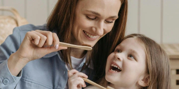 Child brushing teeth with a soft toothbrush